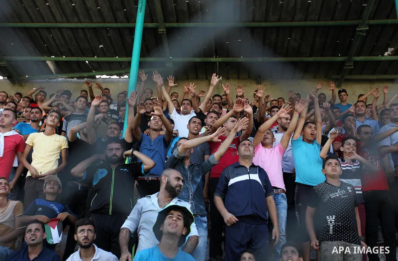 Palestinian spectators watch the first leg of the Palestine Cup final soccer match between Gaza Strip's Khan Younis Youth and Hebron's Al-Ahly at al-Yarmouk stadium in Gaza City July 26, 2016. Photo by Ashraf Amra