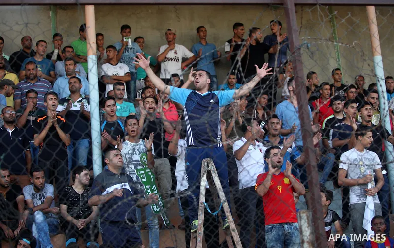 Palestinian spectators watch the first leg of the Palestine Cup final soccer match between Gaza Strip's Khan Younis Youth and Hebron's Al-Ahly at al-Yarmouk stadium in Gaza City July 26, 2016. Photo by Ashraf Amra
