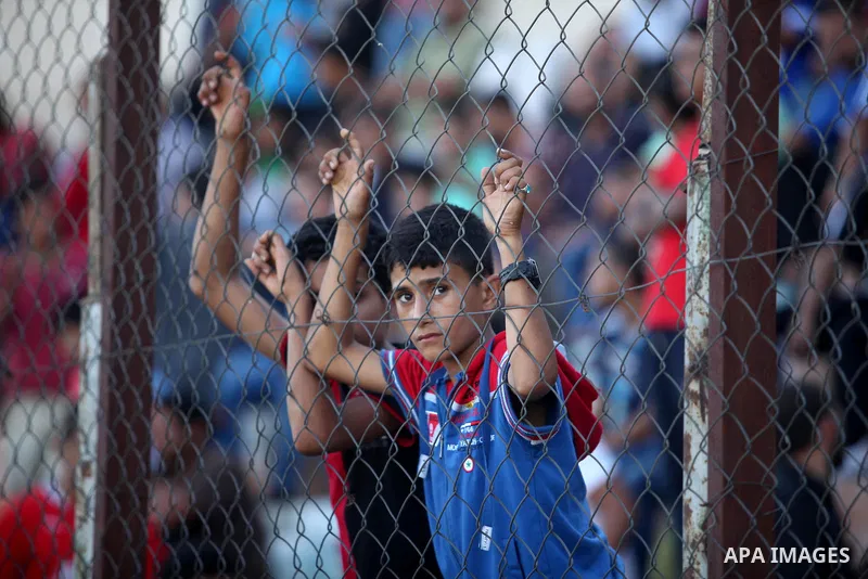 A Palestinian spectator watches the first leg of the Palestine Cup final soccer match between Gaza Strip's Khan Younis Youth and Hebron's Al-Ahly at al-Yarmouk stadium in Gaza City July 26, 2016. Photo by Ashraf Amra