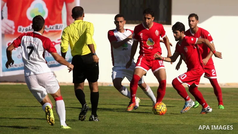 Palestinian Gaza Strip's Khan Younis Youth and Hebron's players compete during the first leg of the Palestine Cup final soccer match at al-Yarmouk stadium in Gaza City July 26, 2016. Photo by Ashraf Amra