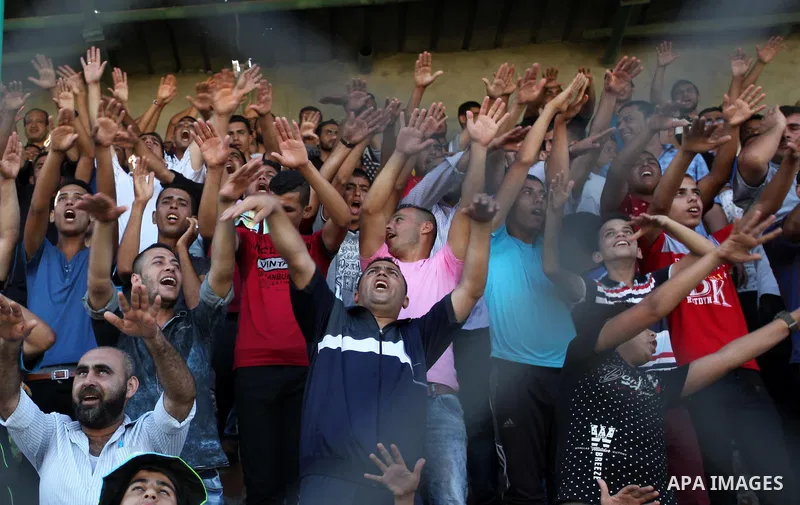 Palestinian spectators watch the first leg of the Palestine Cup final soccer match between Gaza Strip's Khan Younis Youth and Hebron's Al-Ahly at al-Yarmouk stadium in Gaza City July 26, 2016. Photo by Ashraf Amra