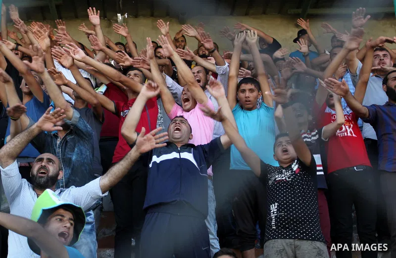 Palestinian spectators watch the first leg of the Palestine Cup final soccer match between Gaza Strip's Khan Younis Youth and Hebron's Al-Ahly at al-Yarmouk stadium in Gaza City July 26, 2016. Photo by Ashraf Amra