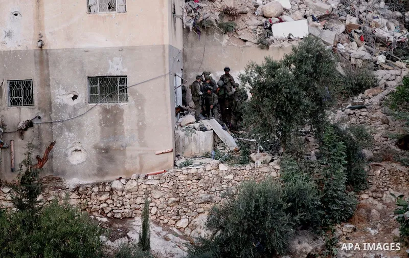 Israeli forces patrol near the house where Palestinian Mohammad al-Fakih was shot dead by Israeli troops during a raid in the West Bank village of Surif, near Hebron July 27, 2016. Photo by Wisam Hashlamoun