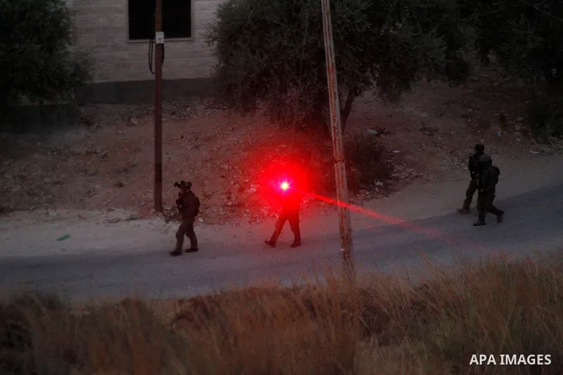 Israeli forces patrol near the house where Palestinian Mohammad al-Fakih was shot dead by Israeli troops during a raid in the West Bank village of Surif, near Hebron July 27, 2016. Photo by Wisam Hashlamoun