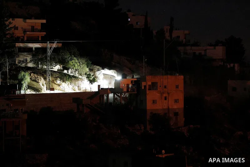 Flames are seen during a raid by Israeli forces on a house in which Palestinian Mohammad al-Fakih was hiding out in the West Bank village of Surif, near Hebron July 27, 2016. Photo by Wisam Hashlamoun