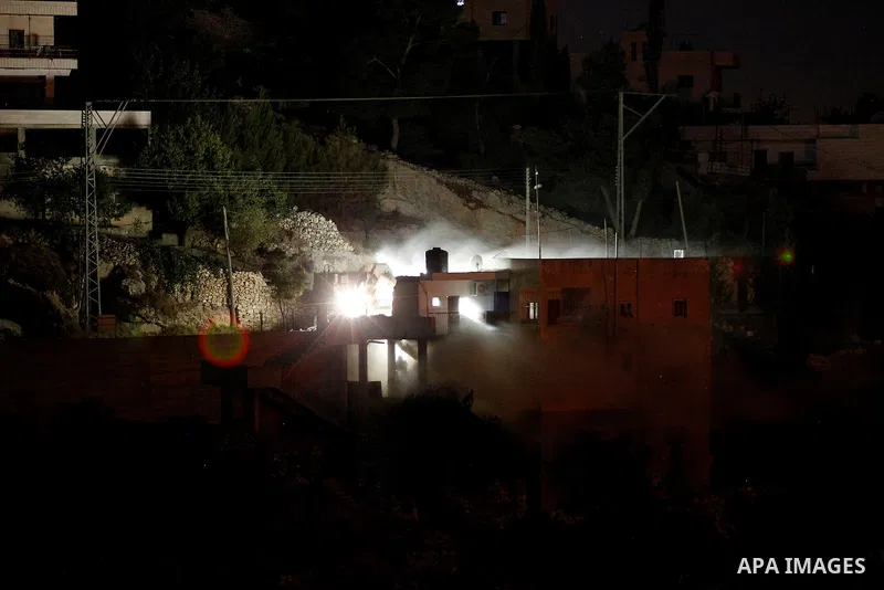 Flames are seen during a raid by Israeli forces on a house in which Palestinian Mohammad al-Fakih was hiding out in the West Bank village of Surif, near Hebron July 27, 2016. Photo by Wisam Hashlamoun