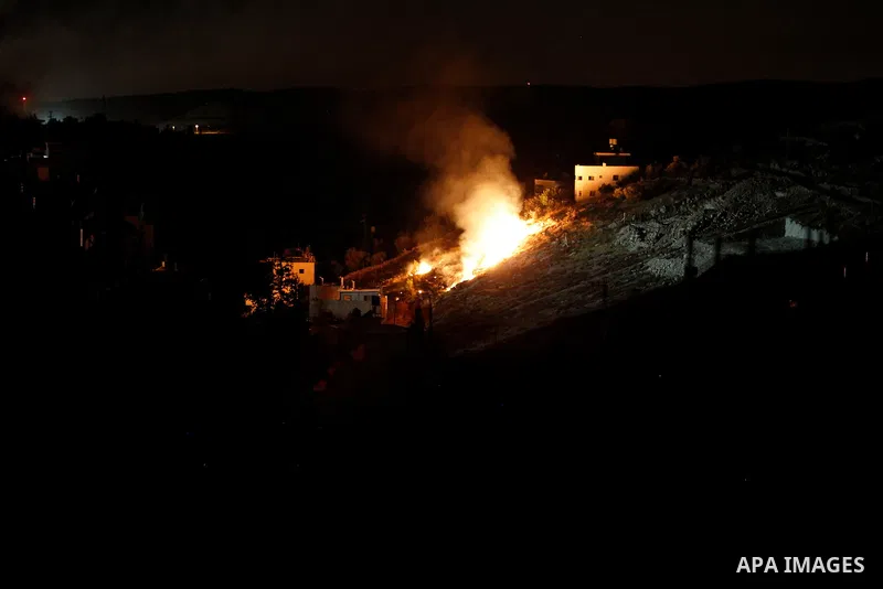 Flames are seen during a raid by Israeli forces on a house in which Palestinian Mohammad al-Fakih was hiding out in the West Bank village of Surif, near Hebron July 27, 2016. Photo by Wisam Hashlamoun