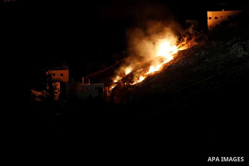 Flames are seen during a raid by Israeli forces on a house in which Palestinian Mohammad al-Fakih was hiding out in the West Bank village of Surif, near Hebron July 27, 2016. Photo by Wisam Hashlamoun