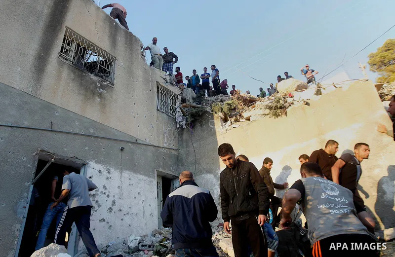 Palestinians check the damage to a house where Mohammad al-Fakih, who was shot dead by Israeli troops during a raid on a house in which he was hiding out, in the West Bank village of Surif, near Hebron July 27, 2016. Pho...