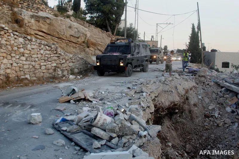 Israeli forces patrol near the house where Palestinian Mohammad al-Fakih was shot dead by Israeli troops during a raid in the West Bank village of Surif, near Hebron July 27, 2016. Photo by Wisam Hashlamoun