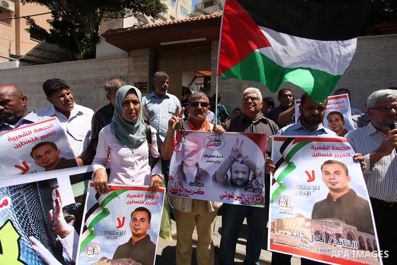Palestinians take part in a protest demanding for the release of Bilal Kayed a Palestinian prisoner on hunger strike, in front of Red Cross office, in Gaza city, on July 28, 2016. Photo by Ashraf Amra