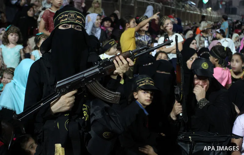 Palestinian female militants from the Al-Quds Brigades, the armed wing of the Islamic Jihad movement, take part in a rally in Rafah in the southern Gaza Strip on July 28, 2016. Photo by Abed Rahim Khatib