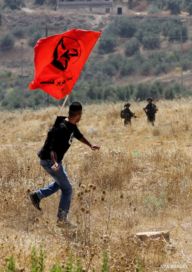 Palestinian activists from the Popular Front of the Liberation of Palestine (PFLP) demonstrate at the Hawara checkpoint near the West Bank city of Nablus on July 29, 2016, against the detention of Bilal Kayed, a fellow P...