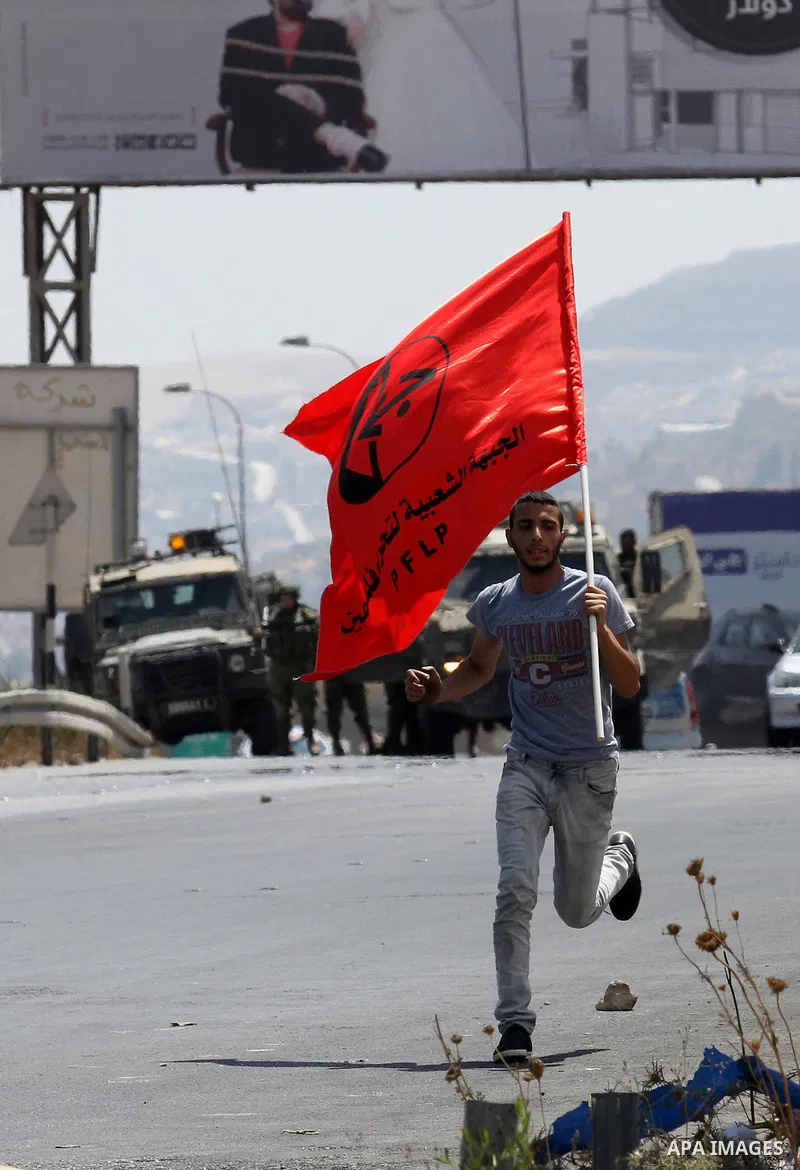 Palestinian activists from the Popular Front of the Liberation of Palestine (PFLP) demonstrate at the Hawara checkpoint near the West Bank city of Nablus on July 29, 2016, against the detention of Bilal Kayed, a fellow P...
