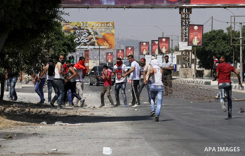 Palestinian activists from the Popular Front of the Liberation of Palestine (PFLP) demonstrate at the Hawara checkpoint near the West Bank city of Nablus on July 29, 2016, against the detention of Bilal Kayed, a fellow P...