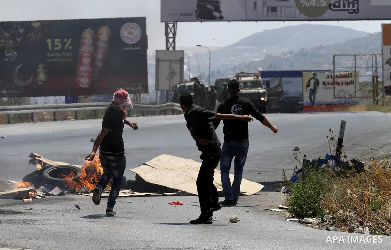 Palestinian activists from the Popular Front of the Liberation of Palestine (PFLP) demonstrate at the Hawara checkpoint near the West Bank city of Nablus on July 29, 2016, against the detention of Bilal Kayed, a fellow P...