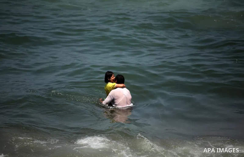 Palestinians swim in the Mediterranean sea on the coast of Gaza city on July 31, 2016. Photo by Ashraf Amra