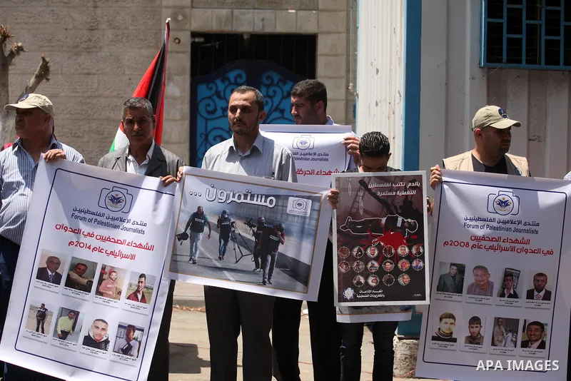 Palestinian Journalists hold banners during a protest calling for stop the Israeli violence against journalists in front of the high commissioner for human rights headquarters in Gaza City, on July 31, 2016. Photo by Ash...