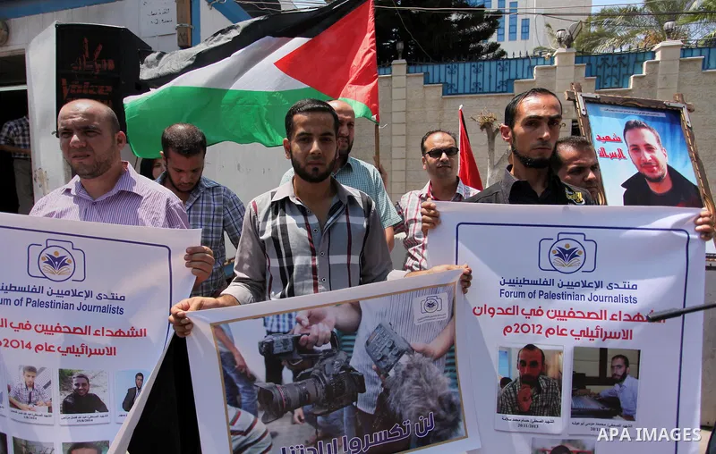 Palestinian Journalists hold banners during a protest calling for stop the Israeli violence against journalists in front of the high commissioner for human rights headquarters in Gaza City, on July 31, 2016. Photo by Ash...