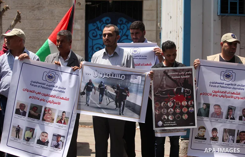 Palestinian Journalists hold banners during a protest calling for stop the Israeli violence against journalists in front of the high commissioner for human rights headquarters in Gaza City, on July 31, 2016. Photo by Ash...