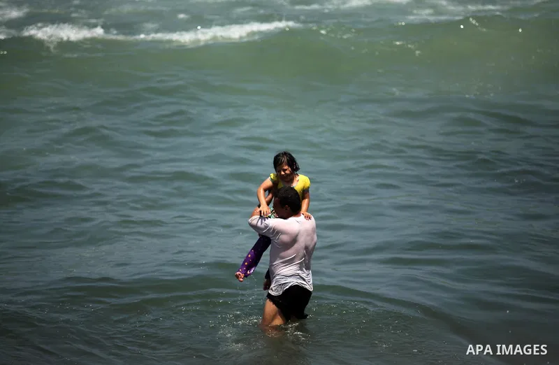 Palestinians swim in the Mediterranean sea on the coast of Gaza city on July 31, 2016. Photo by Ashraf Amra