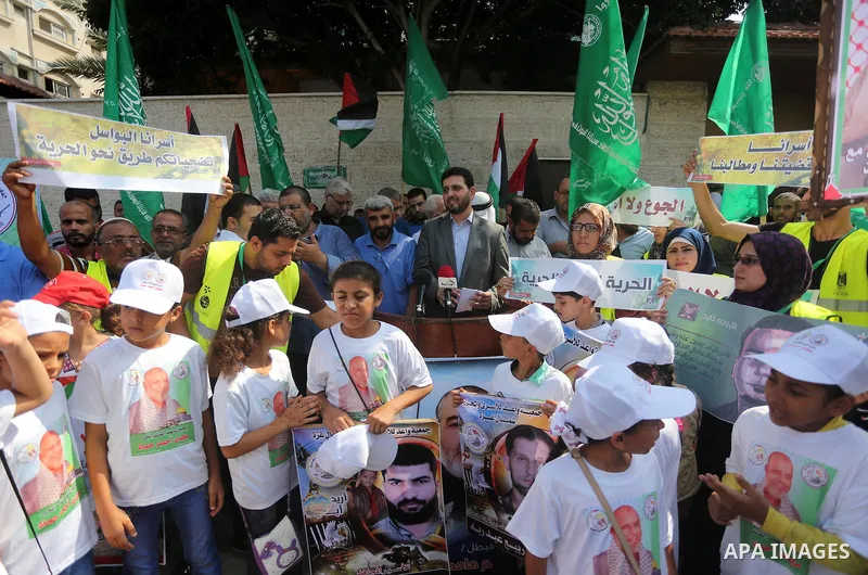 Palestinian children take part in a protest demanding for the release of Bilal Kayed a Palestinian prisoner on hunger strike,, in front of Red cross office, in Gaza city on Aug. 1, 2016. Photo by Mohammed Asad