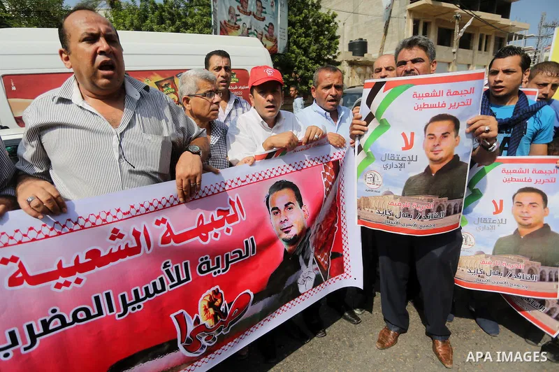 Supporters of the Popular Front for the Liberation of Palestine (PFLP) take part in a protest demanding for the release of Bilal Kayed a Palestinian prisoner on hunger strike,, in front of Red cross office, in Gaza city...