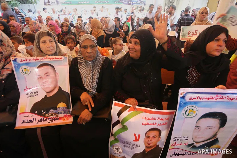 Palestinians take part in a protest demanding release the prisoners in Israeli jails, in front of Red cross office, in Gaza city on Aug. 1, 2016. Photo by Mohammed Asad
