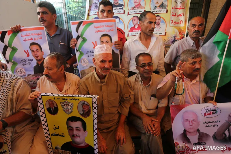 Palestinians take part in a protest demanding release the prisoners in Israeli jails, in front of Red cross office, in Gaza city on Aug. 1, 2016. Photo by Mohammed Asad