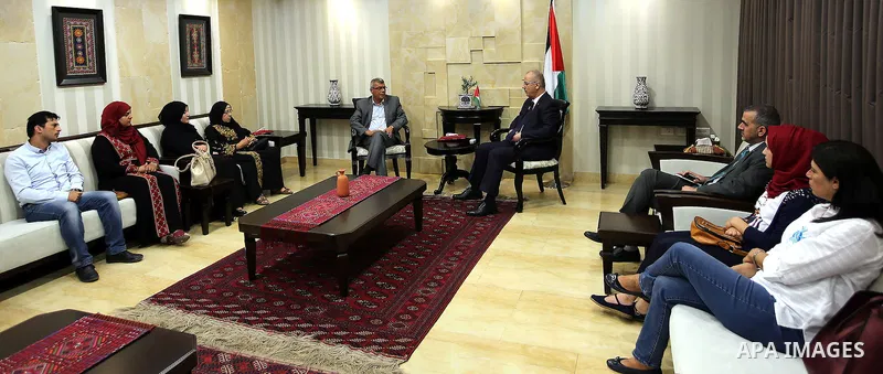 Palestinian Prime Minister, Rami Hamadallah, meets with families of prisoners hunger strikers in Israeli jails Bilal Kayed and brothers Mohammed and Mahmoud Al-balbol, in the West Bank city of Ramallah, on Aug 1, 2016. P...