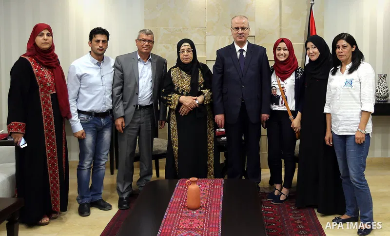 Palestinian Prime Minister, Rami Hamadallah, meets with families of prisoners hunger strikers in Israeli jails Bilal Kayed and brothers Mohammed and Mahmoud Al-balbol, in the West Bank city of Ramallah, on Aug 1, 2016. P...