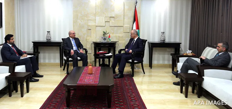 Palestinian Prime Minister, Rami Hamadallah, meets with President of the National Committee for the reconstruction of the Gaza Strip, Ambassador Mohammed Al Emadi, in the West Bank city of Ramallah, on Aug 1, 2016. Photo...