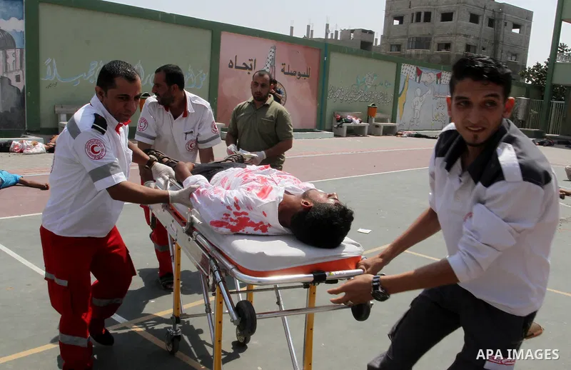 Palestinian rescue workers take part in an emergency simulation exercise in the border city of Rafah, in the southern Gaza Strip, on August 1, 2016. Photo by Abed Rahim Khatib
