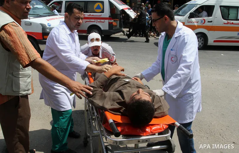 Palestinian rescue workers take part in an emergency simulation exercise in the border city of Rafah, in the southern Gaza Strip, on August 1, 2016. Photo by Abed Rahim Khatib
