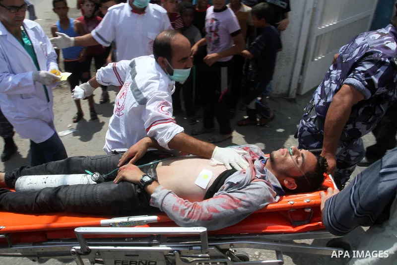 Palestinian rescue workers take part in an emergency simulation exercise in the border city of Rafah, in the southern Gaza Strip, on August 1, 2016. Photo by Abed Rahim Khatib