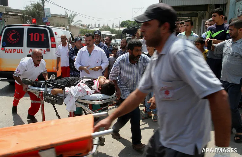 Palestinian rescue workers take part in an emergency simulation exercise in the border city of Rafah, in the southern Gaza Strip, on August 1, 2016. Photo by Abed Rahim Khatib