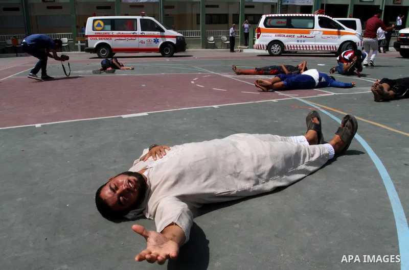 Palestinian rescue workers take part in an emergency simulation exercise in the border city of Rafah, in the southern Gaza Strip, on August 1, 2016. Photo by Abed Rahim Khatib