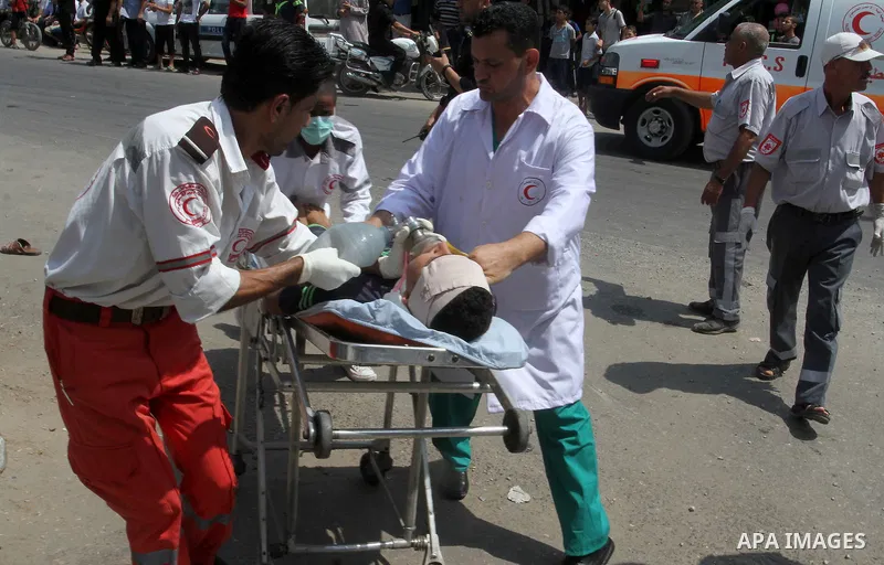 Palestinian rescue workers take part in an emergency simulation exercise in the border city of Rafah, in the southern Gaza Strip, on August 1, 2016. Photo by Abed Rahim Khatib