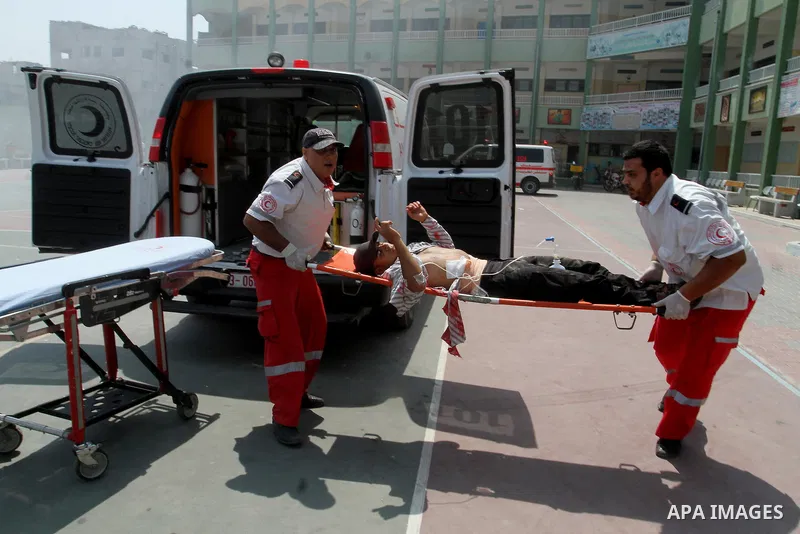 Palestinian rescue workers take part in an emergency simulation exercise in the border city of Rafah, in the southern Gaza Strip, on August 1, 2016. Photo by Abed Rahim Khatib