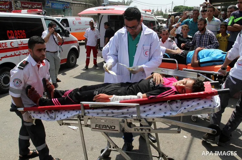Palestinian rescue workers take part in an emergency simulation exercise in the border city of Rafah, in the southern Gaza Strip, on August 1, 2016. Photo by Abed Rahim Khatib