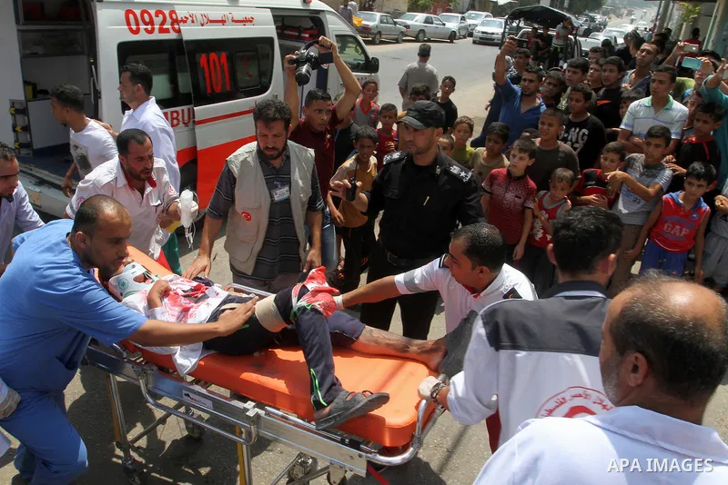 Palestinian rescue workers take part in an emergency simulation exercise in the border city of Rafah, in the southern Gaza Strip, on August 1, 2016. Photo by Abed Rahim Khatib