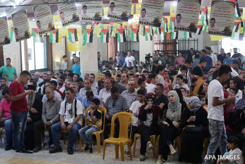 Palestinians attend a memorial service for Laith al-Khalidi who was killed by Israeli soldiers on August 1, 2015, during a demonstration after Jewish settlers attack Dawabsha family home, in Jalazoun refugee camp near th...