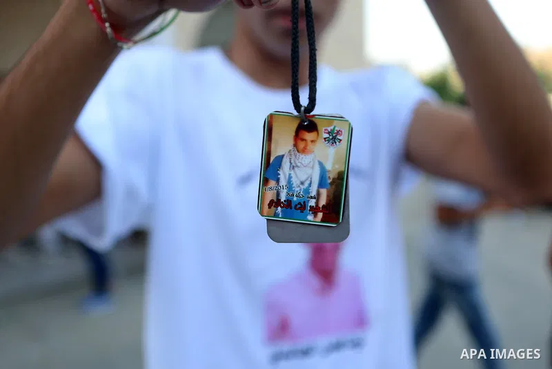 Palestinians attend a memorial service for Laith al-Khalidi who was killed by Israeli soldiers on August 1, 2015, during a demonstration after Jewish settlers attack Dawabsha family home, in Jalazoun refugee camp near th...