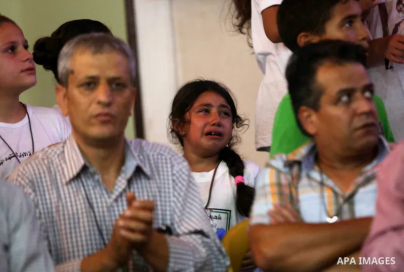 Palestinians attend a memorial service for Laith al-Khalidi who was killed by Israeli soldiers on August 1, 2015, during a demonstration after Jewish settlers attack Dawabsha family home, in Jalazoun refugee camp near th...