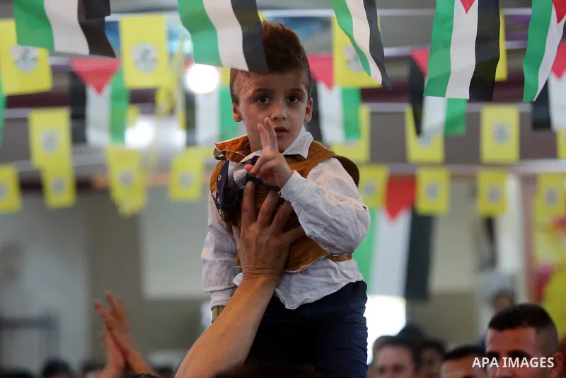 Palestinians carry Ahmed Dawabsha, who suffered severe burns in an arson attack by suspected Jewish attackers on his family home last year in which his younger brother, Ali, and his parents both died, during a memorial s...