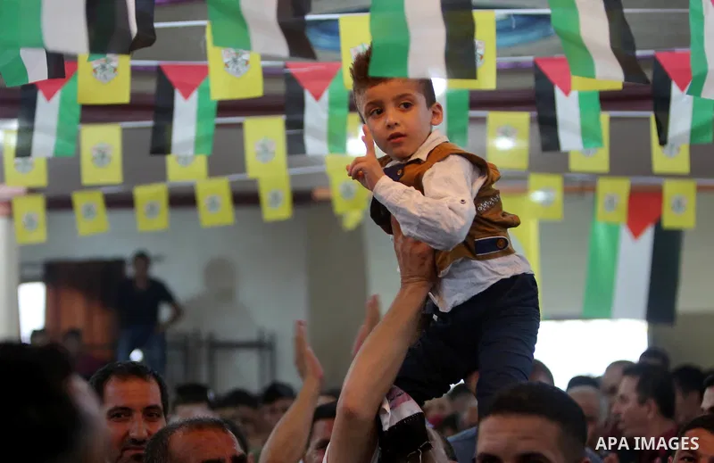 Palestinians carry Ahmed Dawabsha, who suffered severe burns in an arson attack by suspected Jewish attackers on his family home last year in which his younger brother, Ali, and his parents both died, during a memorial s...