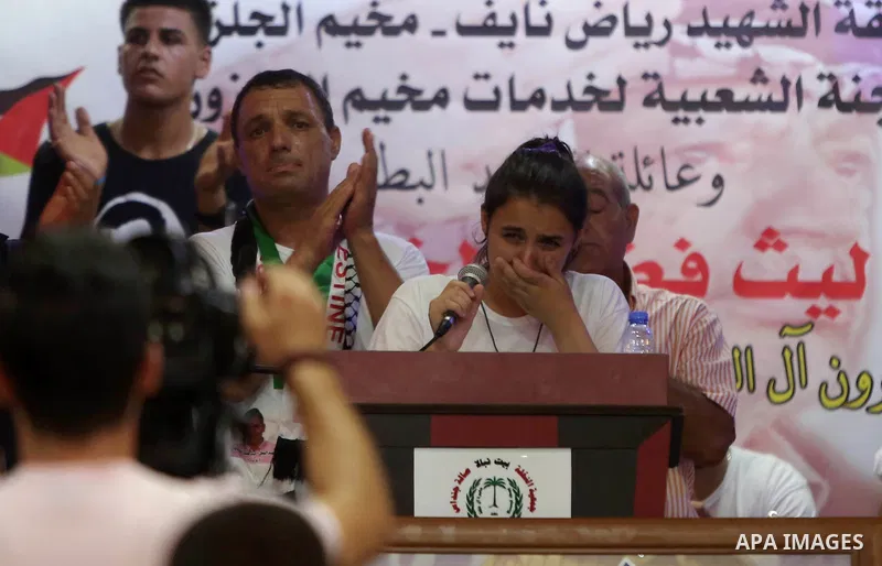 Palestinians attend a memorial service for Laith al-Khalidi who was killed by Israeli soldiers on August 1, 2015, during a demonstration after Jewish settlers attack Dawabsha family home, in Jalazoun refugee camp near th...