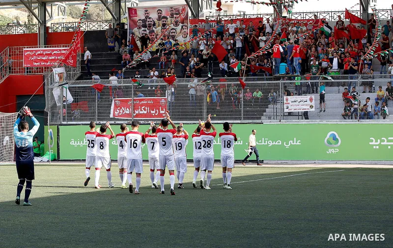 Fans of Hebron's football club Ahly al-Khalil cheer before a second leg match against Shabab Khan Yunis for the Palestinian Cup final on August 2, 2016 at Hussein Bin Ali Stadium in the West Bank city of Hebron. The matc...