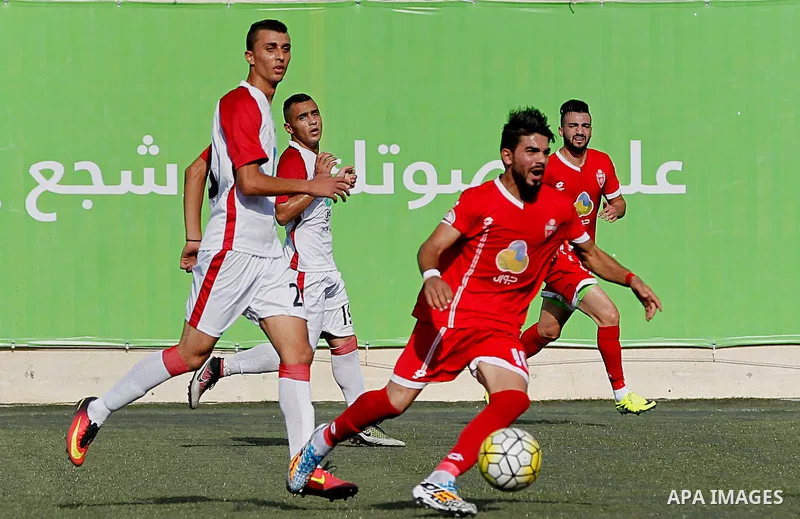 Ahly al-Khalil players and Shabab Khan Yunis players compete during thier a second leg match for the Palestinian Cup final on August 2, 2016 at Hussein Bin Ali Stadium in the West Bank city of Hebron. The match had origi...