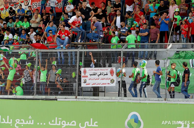 Fans of Hebron's football club Ahly al-Khalil cheer before a second leg match against Shabab Khan Yunis for the Palestinian Cup final on August 2, 2016 at Hussein Bin Ali Stadium in the West Bank city of Hebron. The matc...